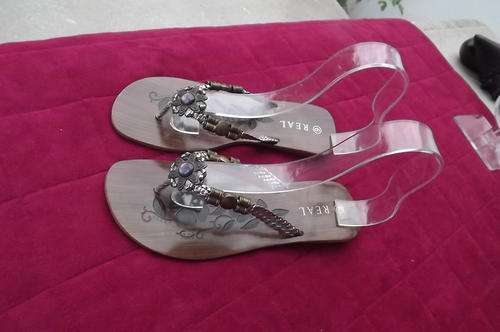 Pair of flat sandles in metal colours with pretty decoration in size 6 by Real.As new.Used once