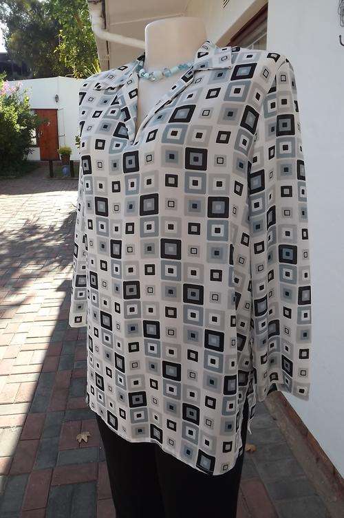 White,grey and black long sleeve polyester top in square patterns by Truworths in size 36/12.