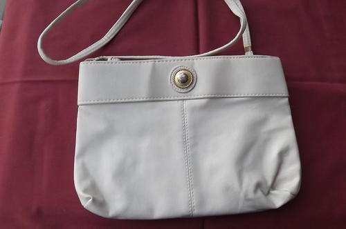 Beige sling bag in good condition.Two zipped compartments 27 x 19 cm