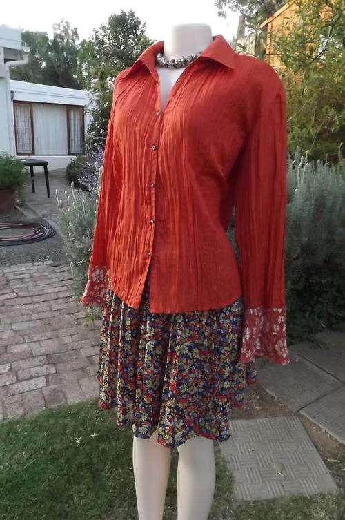 Burnt orange colour blouse with permanent pleats by Oasis in size 40/16.100% Polyester.Made in India