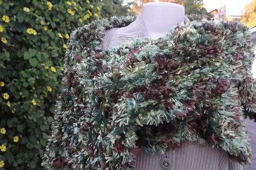 Fluffy knitted scarf in greens and brown.Acrylic knit.Length 170 cm. Width 22 cm. Good condition