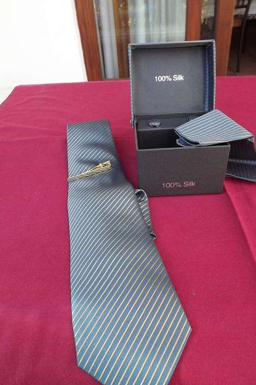 Boxed 100% silk 4 piece tie set.Steel blue with gold brown diagonal stripes.Width 9cm.Handmade tie.