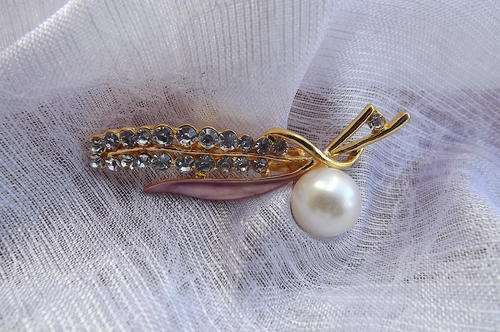 Brooch with enamel leaf and simulated diamonds.New