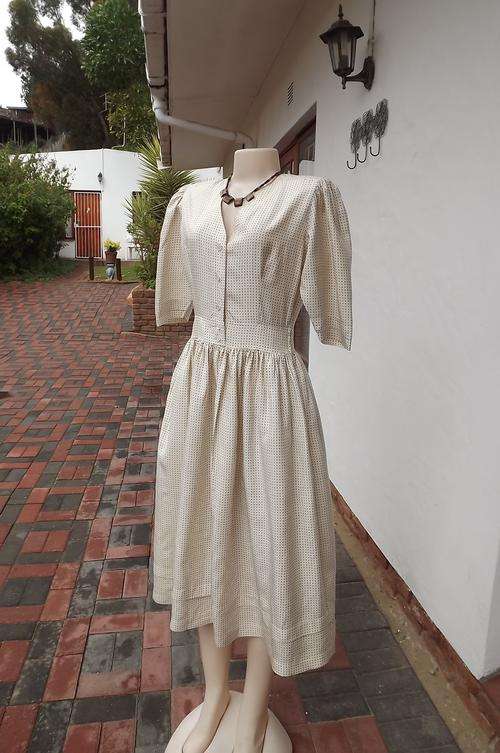Silk cream dress with brown dots by Cordier in size 33/9.Gathered in middle with wide skirt.