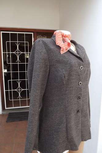 Warm light brown jersey look jacket.Size 36/12.Boutique made.Close with 4 buttons.Tailored.Good cond
