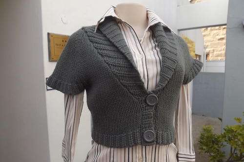 Grey colour short sleeve double knit bolero size 30/6.100% Acrylic.Wide collar.Close with 2 buttons