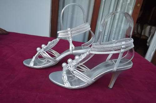 Pair of silver high heel sandles by Booz size 3.Straps around ankle.Used a few times but in good con