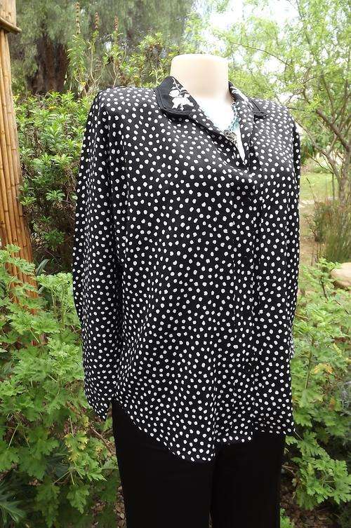 Fabulous black with white design blouse with dolman sleeves.Size 40/16.Black embroidered collar.