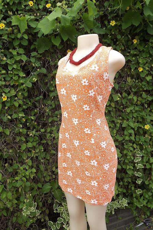 Plain but pretty orange and white floral pattern.Knee length dress size 36/12.As new condition