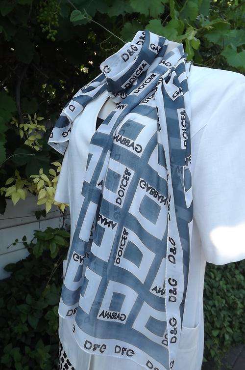 Sheer polyester scarf in grey and white blocks and words Dolche & Gabbana.Width 52cm.Length 152cm.