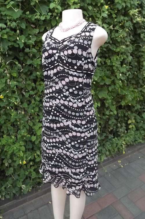 Black sheer lined empire style dress in black with pink/purple polka dots. Size 35/11. New condition