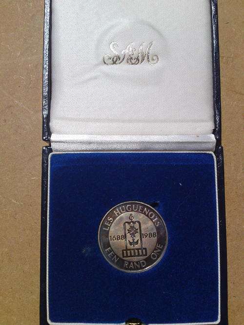 1988 Huguenots silver R1. Blue and pink tinting. In SA mint box. Reduced to go