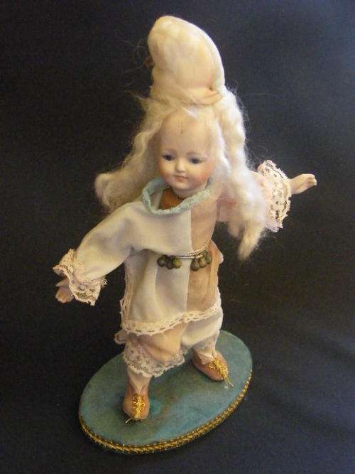 Porcelain and wood doll as per photo