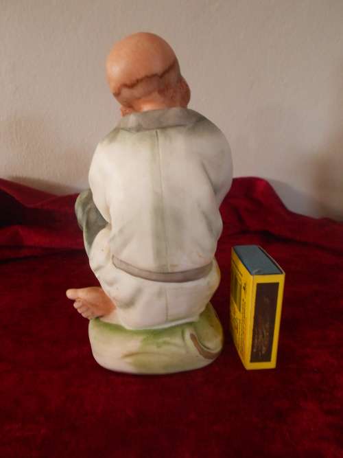 Vintage Oriental Man/Bird in Hand Figurine, marked "Speak to me", Bisque Finish