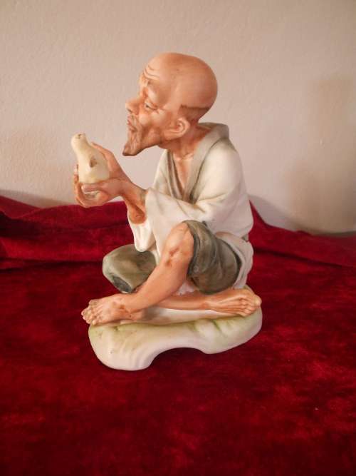 Vintage Oriental Man/Bird in Hand Figurine, marked "Speak to me", Bisque Finish