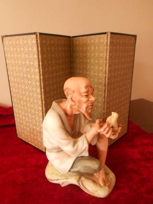 Vintage Oriental Man/Bird in Hand Figurine, marked "Speak to me", Bisque Finish
