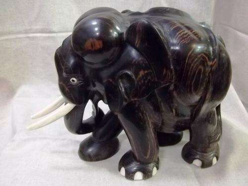 CARVED EBONY ELEPHANT WITH IVORY TUSKS