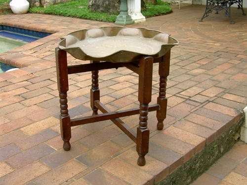 Antique table with removable brass top and folding legs.