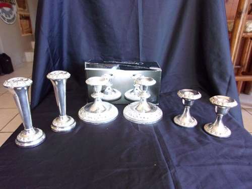 2 Vintage pairs of silver plated candlesticks (1 boxed) and a pair of plated vases for 1 bid