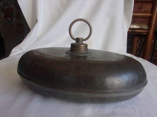 Antique oval metal and pewter hot water bottle/ foot warmer with brass lid