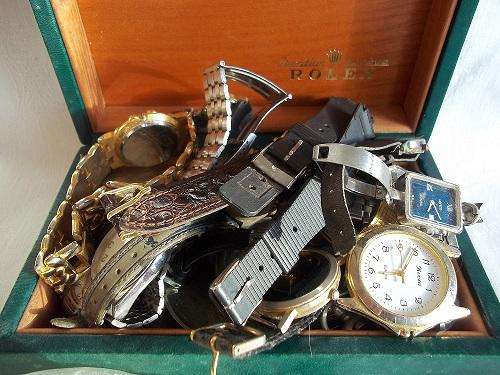 Rolex box filled with vintage pocket watch casings, watches and parts