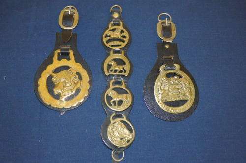 A COLLECTION OF THREE SOLID BRASS "HORSE BRASS" MEDALLIONS MOUNTED ON "LEATHER" STRAPS bid/ strap