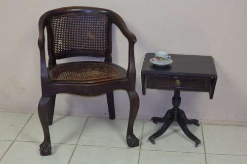 AN EXQUISITE AND VERY STYLISH VINTAGE TEAK RATTAN ARM CHAIR WITH A SOLIDLY BUILT FRAME