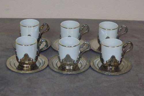 A REMARKABLE SET OF SIX "MPA" PORCELAIN COFFEE CUPS IN ART NOUVEAU STYLE METAL HOLDERS WITH SAUCERS