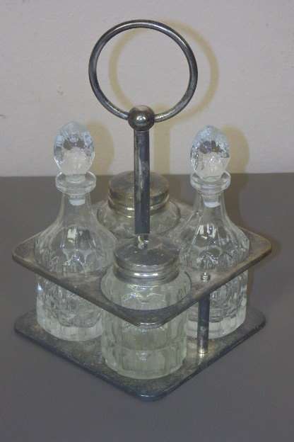 A WONDERFUL VINTAGE GLASS AND SILVER PLATED CRUET SET IN A SILVER PLATED STAND