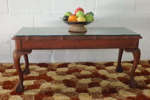 AN EXQUISITE SOLID IMBUIA BALL AND CLAW CENTRE COFFEE/ OCCASIONAL TABLE WITH A GLASS TOP
