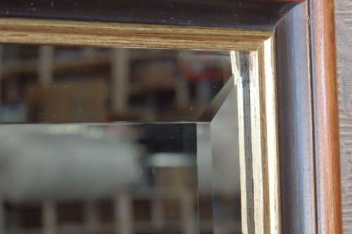 A BEAUTIFUL DARK WOODEN FRAMED BEVELED GLASS MIRROR WITH GOLD GILDING, GORGEOUS FOR ANY HOME