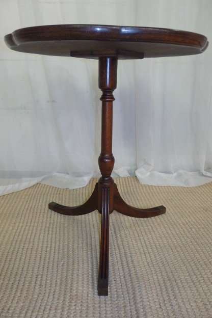 A MAGNIFICENT TEAK OCCASIONAL TABLE WITH BROAD RIMMED DETAILED TOP AND THREE BRASS TOE CAPS