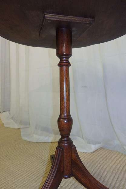 A MAGNIFICENT TEAK OCCASIONAL TABLE WITH BROAD RIMMED DETAILED TOP AND THREE BRASS TOE CAPS
