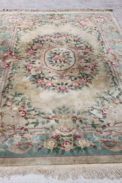 A WONDERFUL ANTIQUE PURE WOOL PILE CARPET (2.9m x 1.8m) WITH GREENS, PINKS, TANS AND EARTHY TONES