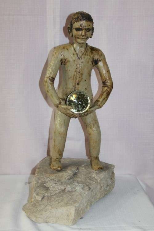 A SUPERB LARGE ONE-OF-A-KIND HAND SCULPTED STONEWARE "MAN" SCULPTURE HOLDING A GLASS BALL