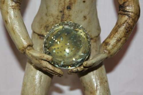 A SUPERB LARGE ONE-OF-A-KIND HAND SCULPTED STONEWARE "MAN" SCULPTURE HOLDING A GLASS BALL