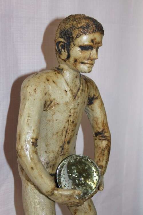 A SUPERB LARGE ONE-OF-A-KIND HAND SCULPTED STONEWARE "MAN" SCULPTURE HOLDING A GLASS BALL