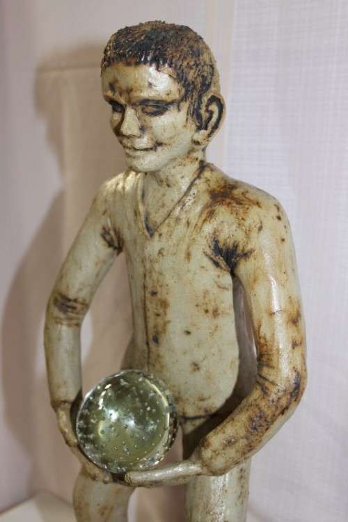 A SUPERB LARGE ONE-OF-A-KIND HAND SCULPTED STONEWARE "MAN" SCULPTURE HOLDING A GLASS BALL
