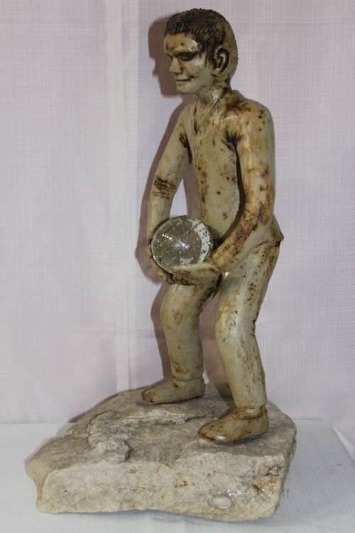 A SUPERB LARGE ONE-OF-A-KIND HAND SCULPTED STONEWARE "MAN" SCULPTURE HOLDING A GLASS BALL
