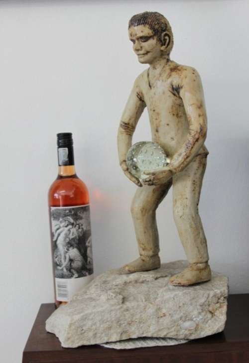 A SUPERB LARGE ONE-OF-A-KIND HAND SCULPTED STONEWARE "MAN" SCULPTURE HOLDING A GLASS BALL