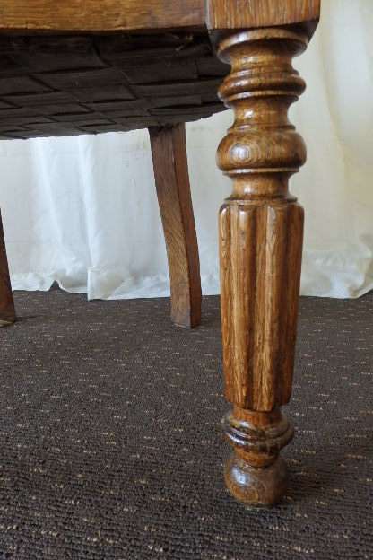 A SPECTACULAR ANTIQUE HAND CARVED SOLID OAK CAPTAINS CHAIR WITH "SHERATON" FLUTED TURNED LEGS