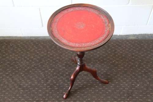 A stunning Victorian antique mahogany occasional table w/ a leather clad top and scalloped rim