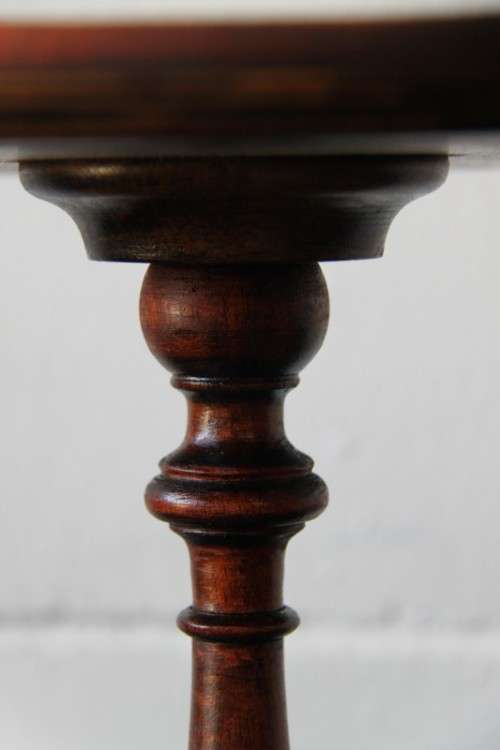 A stunning Victorian antique mahogany occasional table w/ a leather clad top and scalloped rim
