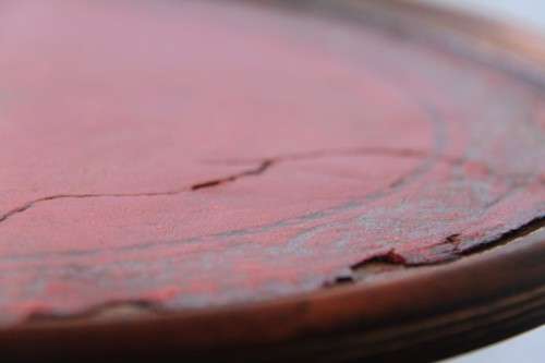 A stunning Victorian antique mahogany occasional table w/ a leather clad top and scalloped rim