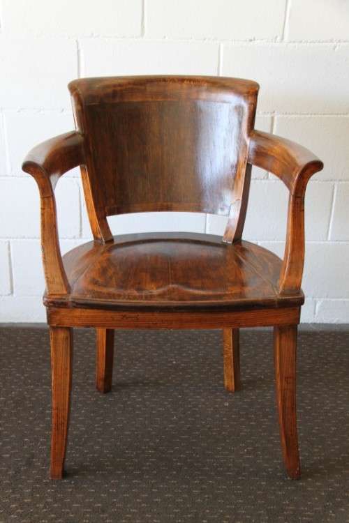A gorgeous Edwardian antique oak fire house captain's chair with beautiful carved arm rests