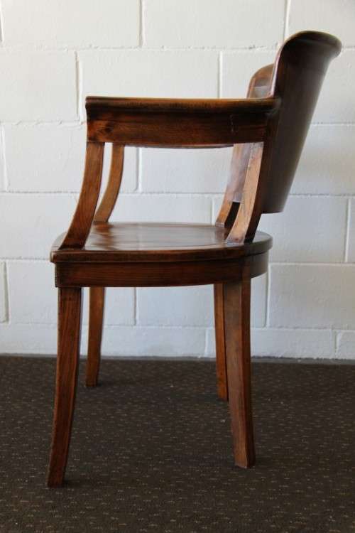 A gorgeous Edwardian antique oak fire house captain's chair with beautiful carved arm rests