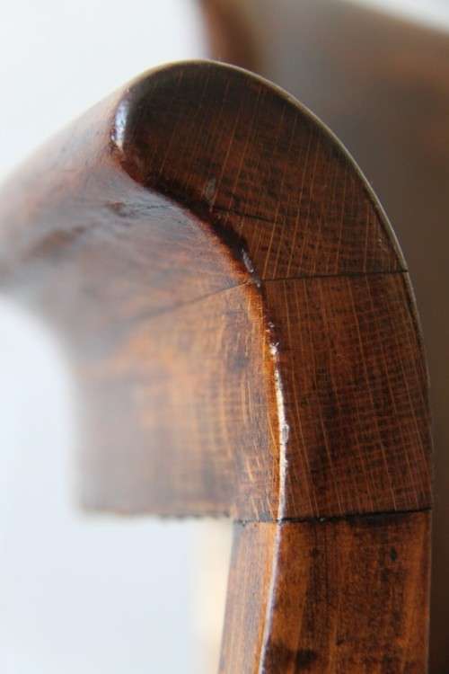 A gorgeous Edwardian antique oak fire house captain's chair with beautiful carved arm rests