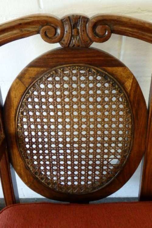 A beautiful solid Stink Wood Ball & Claw parlour couch with wicker backrest in great condition!!!