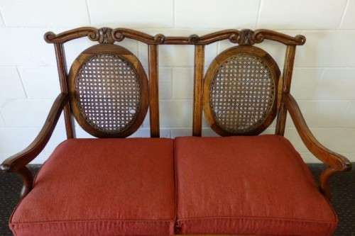 A beautiful solid Stink Wood Ball & Claw parlour couch with wicker backrest in great condition!!!
