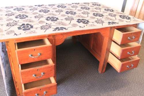 A magnificent large solid oak partners desk with loads of drawer space and ornate handles